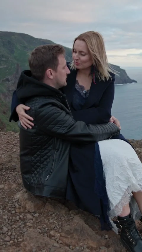 Romantic couple embracing on cliffside at dusk Stock Footage 327035350