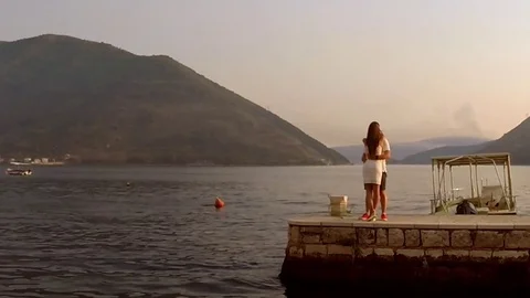 Romantic couple embracing each other on scenic pier. Stock Footage 80245262