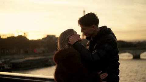 Romantic couple embracing with Eiffel Tower in background Paris France at sunset Stock Footage 325235256