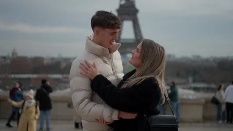 Romantic couple embracing with Eiffel Tower in background Paris France Travel Stock Footage 325247138