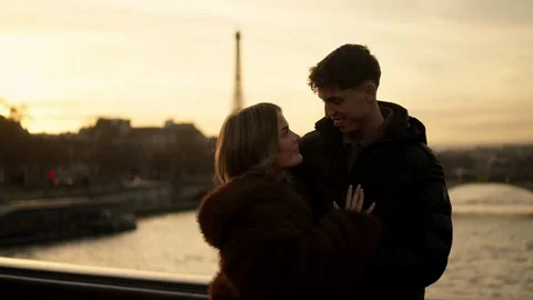 Romantic couple embracing with Eiffel Tower in background at sunset in Paris Stock Footage 325251864