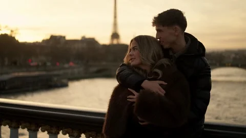 Romantic couple embracing with Eiffel Tower in background Paris France Golden Stock Footage 325255375