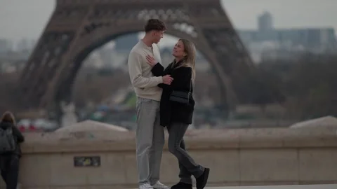 Romantic couple embracing with Eiffel Tower in background Paris France Love and Stock Footage 325260956