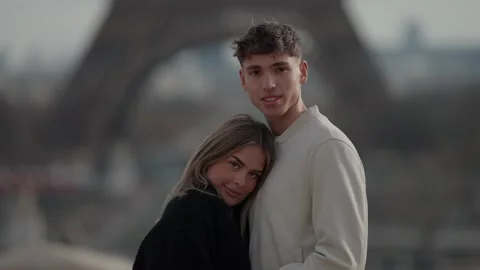 Romantic couple embracing with Eiffel Tower in soft focus background Paris Stock Footage 325261747