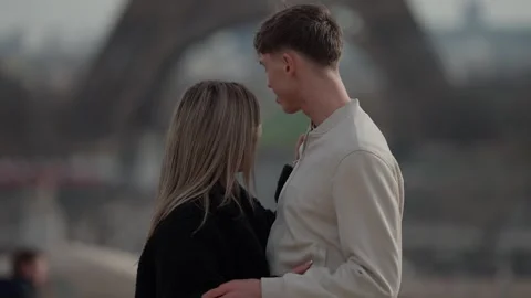 Romantic couple embracing with Eiffel Tower in background Paris France Shallow Stock Footage 325262395