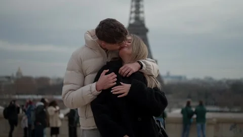 Romantic couple embracing with Eiffel Tower in background Paris France Young Stock Footage 325274290
