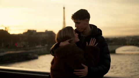 Romantic couple embracing with Eiffel Tower in background Paris France Golden Stock Footage 328566913