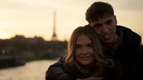 Romantic couple embracing with Eiffel Tower backdrop in Paris France Golden hour Stock Footage 328568484