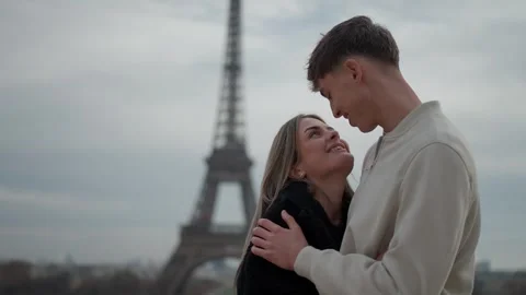 Romantic Couple Embracing in Paris with Eiffel Tower Backdrop Love and Stock Footage 325245501