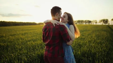 Romantic couple embracing, stroking each other on the background of bright Stock Footage 84652253