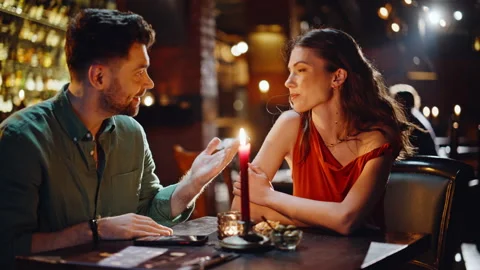 Romantic couple enjoy communication in dark pub closeup. Smiling flirting pair Vídeo Stock 334009039