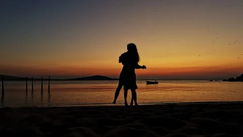 Romantic Couple Enjoying Sunset Dance by the Sea Video stock 335522557