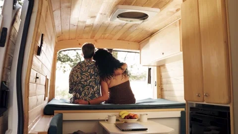 Romantic couple enjoying the view inside a camper van Stock Footage 344824353