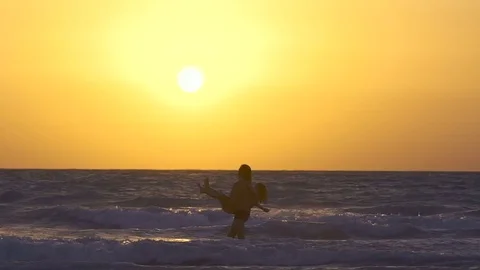 Romantic couple is falling in love on the beach at sunset, kiss each other Video stock 79242778