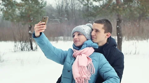 Romantic couple in the forest taking a selfie, winter Stock Footage 85954013
