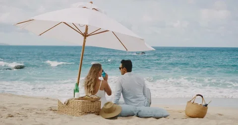 Romantic couple having a beach picnic Stock Footage 116258914
