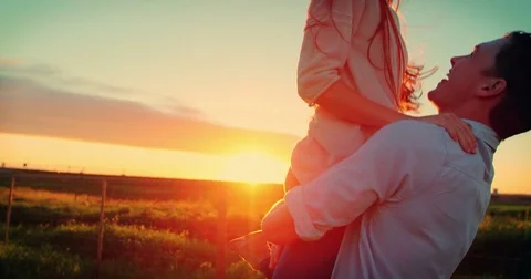Romantic couple having fun in field Stock Footage 75287826