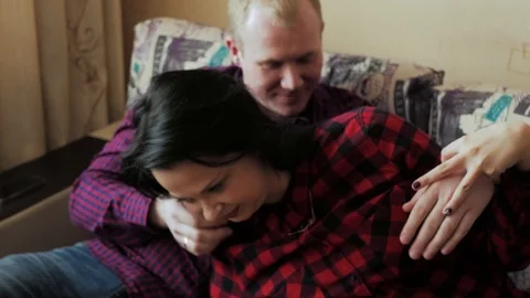 Romantic couple having a great time together in the couch at home Stock Footage 97055582