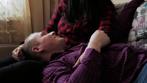 Romantic couple having a great time together in the couch at home Stock Footage 97055849
