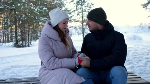 Romantic couple holding hands on bench in winter park 스톡 동영상 330104328