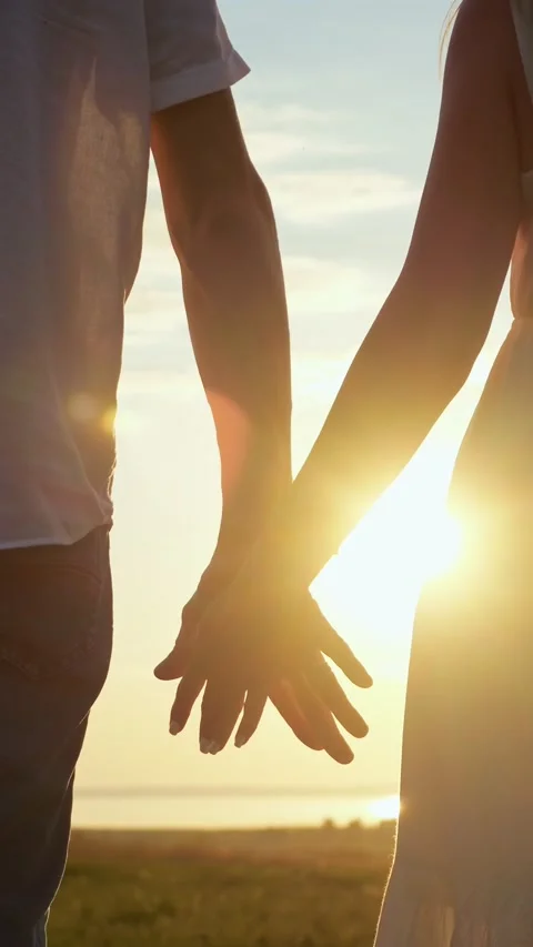 Romantic couple holding hands at sunset Stock Footage 341184427