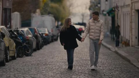 Romantic Couple Holding Hands Walking On Cobblestone Street In Paris France 스톡 사진
