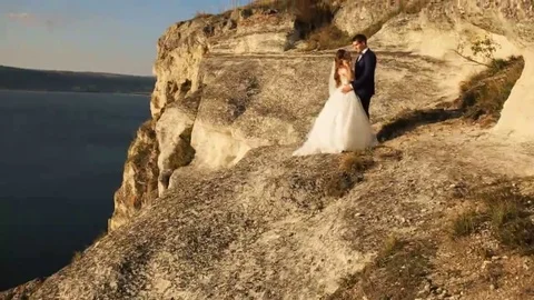 Romantic couple holding hands while walking on the mountain in countryside Stock Footage 69148358