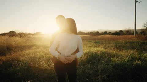 Romantic Couple Hugging each other outdoor At Sunset Light Stock Footage 168869124
