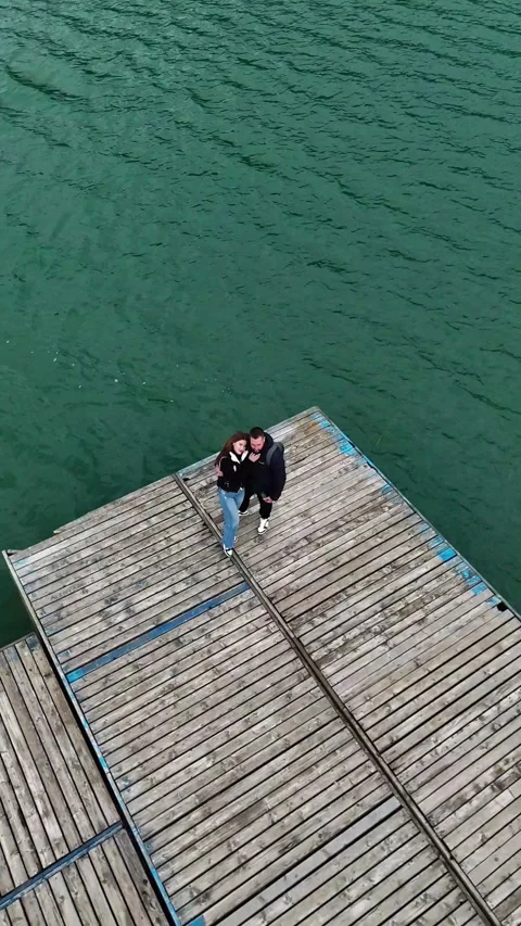 Romantic Couple by the Lake Aerial Pull Back Shot Stock Footage 301452762