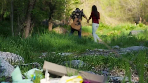 Romantic couple leaving a garbage dump in the forest Slow motion, beautiful Video stock 76009300
