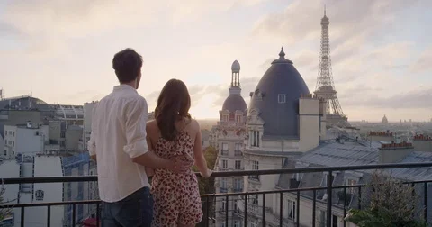 Romantic couple looking out over Paris view from Hotel balcony terrace Eiffel Stock Footage 73335249