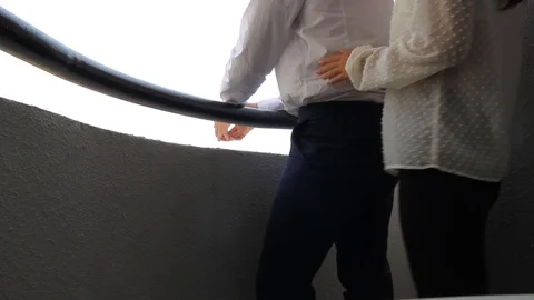 Romantic couple looking out over view from Hotel balcony terrace Stock Footage 107105767