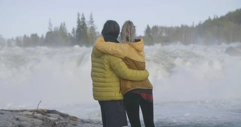 Romantic couple looking at speedy river Stock Footage 85963188