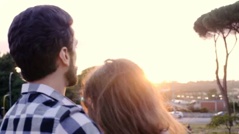 Romantic couple  looking at the view in the reflected light of the sun Stock-Footage 139301533