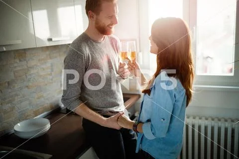 Romantic couple in love spending time together in kitchen Stock Photos
