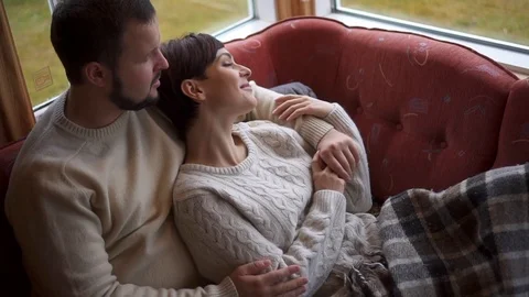 Romantic couple is lying on the sofa at home. Video stock 127515445
