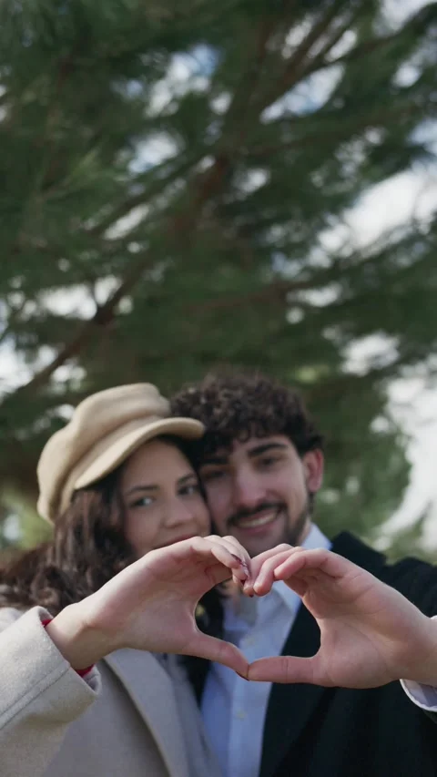 Romantic couple making heart shape with hands Stock Footage 325701366