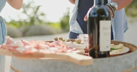 Romantic couple, man and woman toasting with red wine and eating finger food Stock Footage