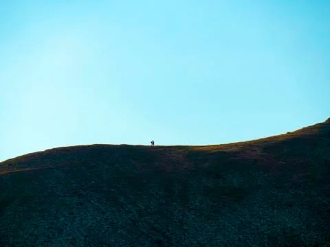 Romantic couple on the mountain, distant plan. Stock Photos