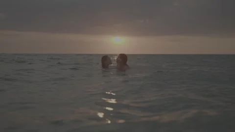 Romantic couple in ocean during sunset Stock-Footage 268072656