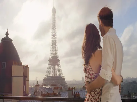 Romantic couple in Paris Eiffel Tower embrace kissing honeymoon enjoying Stock Footage