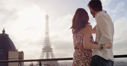 Romantic couple in Paris Eiffel Tower embrace kissing honeymoon enjoying Stock Footage 73347650