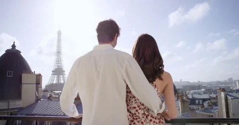 Romantic couple in Paris Eiffel Tower embrace kissing honeymoon enjoying Stock Footage 73350924