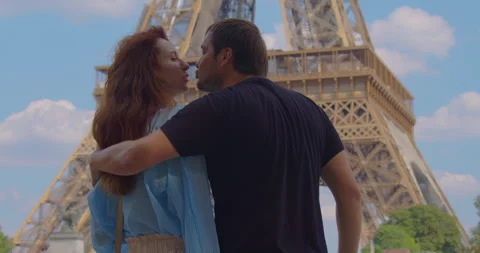 Romantic couple in Paris Eiffel Tower embrace kissing honeymoon enjoying Stock Footage 244330651