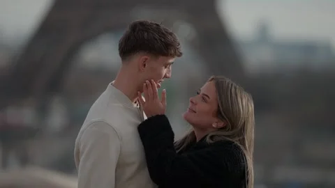 Romantic Couple in Paris with Eiffel Tower Background Woman Touches Man's Stock Footage 325254507