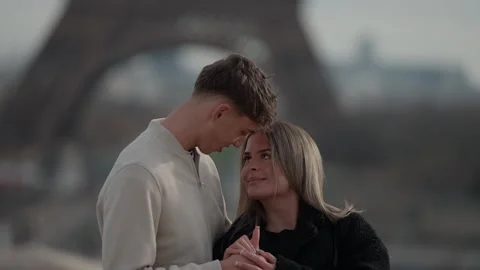 Romantic couple in Paris with Eiffel Tower background Young lovers holding hands Stock Footage 325266292