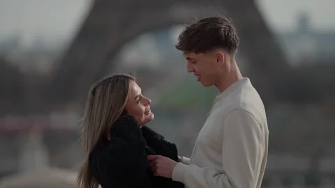 Romantic couple in Paris with Eiffel Tower background Young lovers embracing Stock Footage 328572721