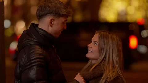 Romantic couple in Paris at night looking at each other with love bokeh lights Stock Footage 328570925