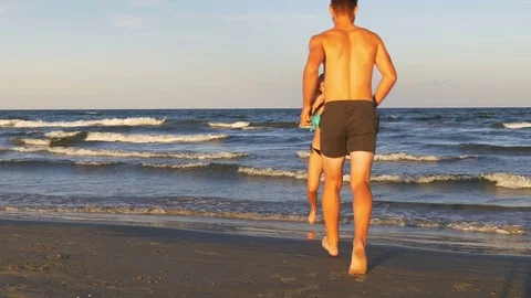 Romantic couple playing and teasing one another in the sea Stock Footage 70611115