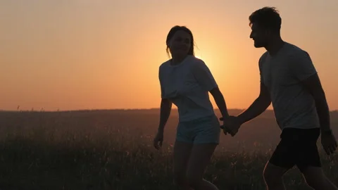 The romantic couple playing on mountain top on sunset background. slow motion Stock Footage 159595475